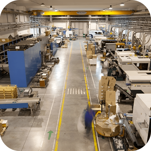 A factory floor with many machines and boxes.